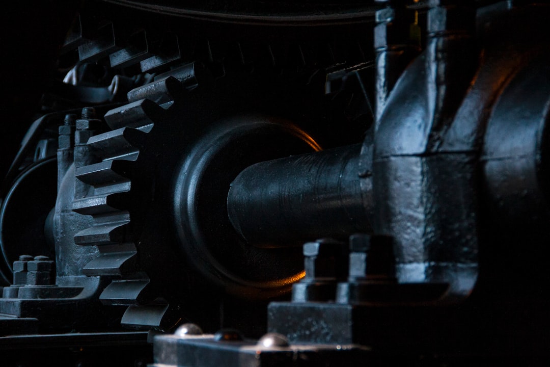 Close-up of industrial gears and machineries in dark lighting