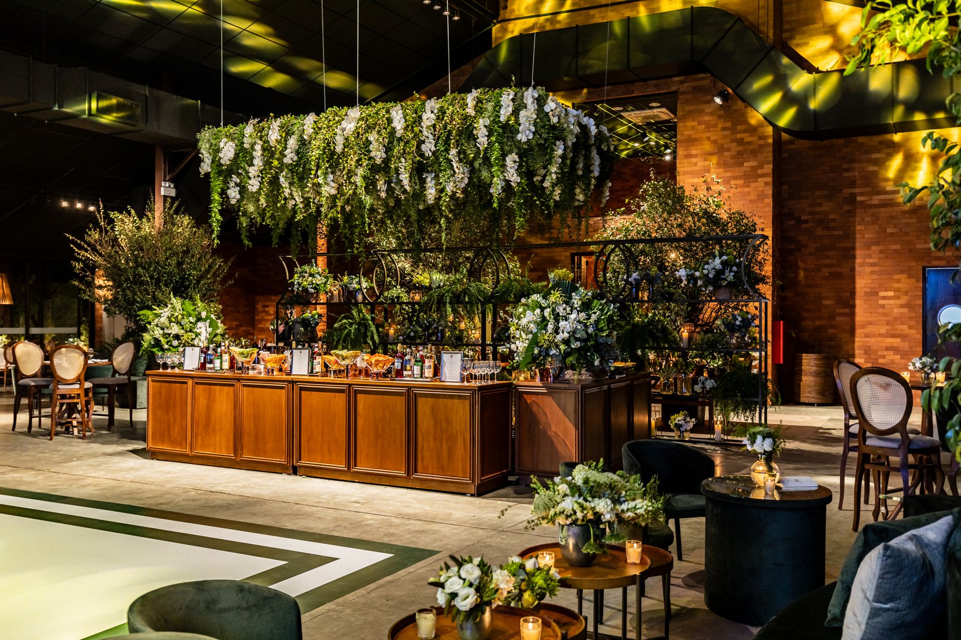 Luxurious indoor event venue with elegant floral decorations and warm lighting. — "Ogee Skirting: Traditional Charm for Moder
