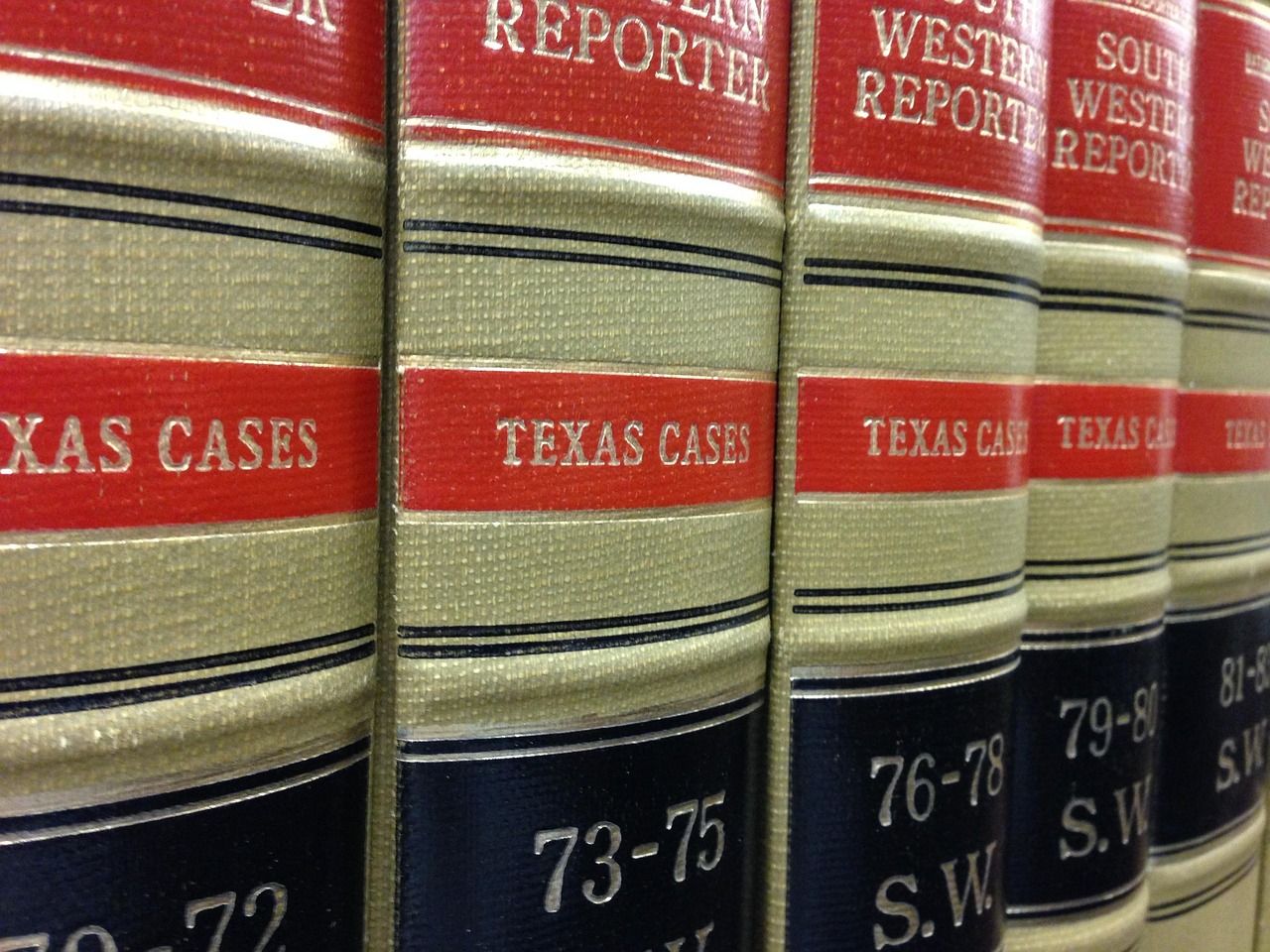 Law books, library, rows of books — The Importance of Choosing a Great Professional Attorney